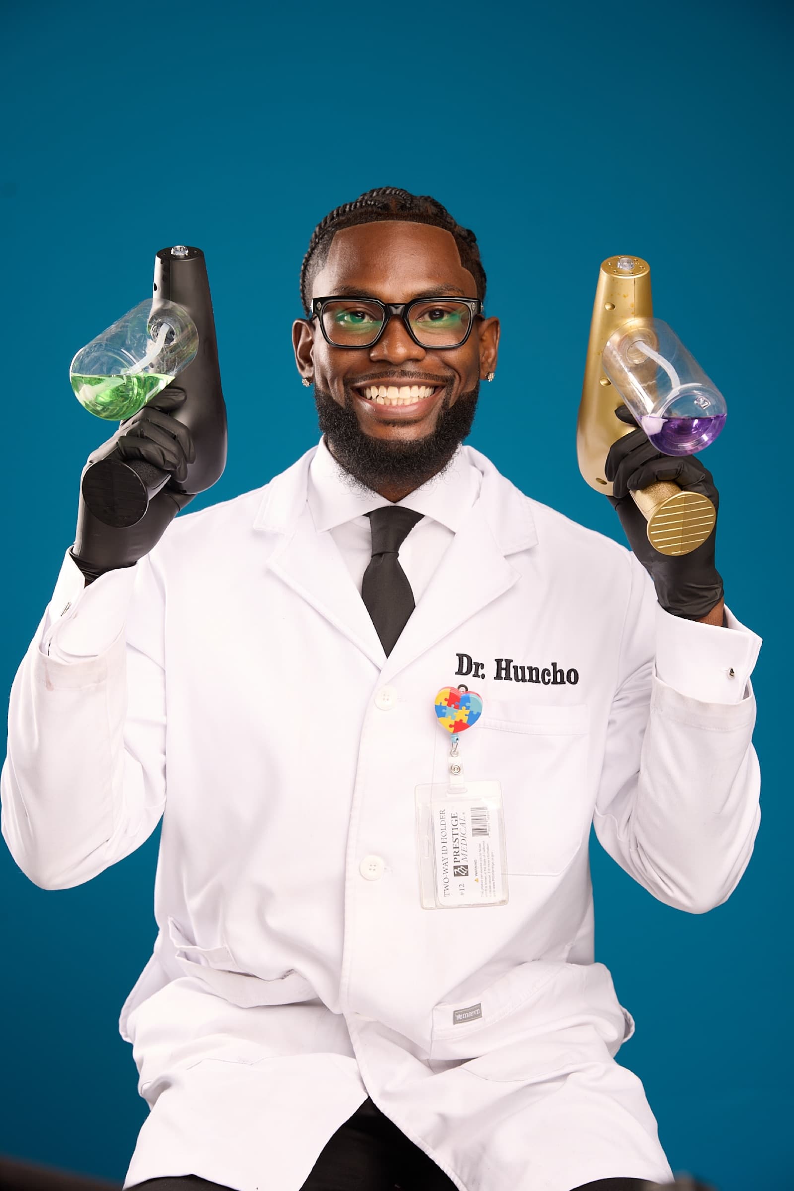 Sly Huncho in a white coat holding two grooming devices